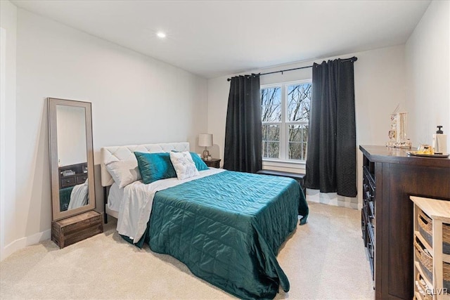 bedroom featuring light colored carpet