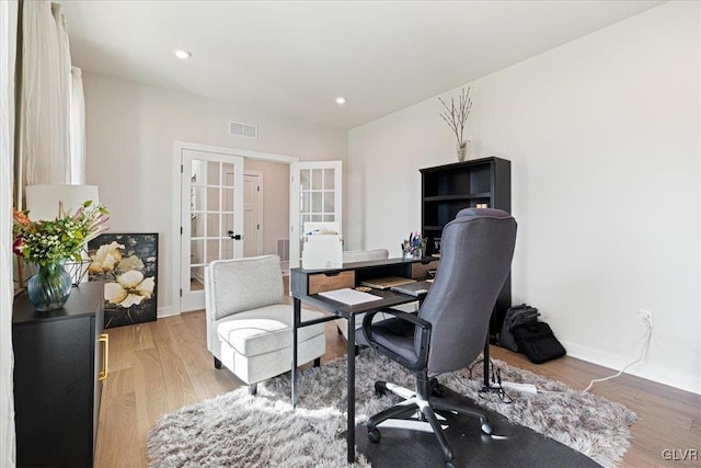 office with french doors and light wood-type flooring