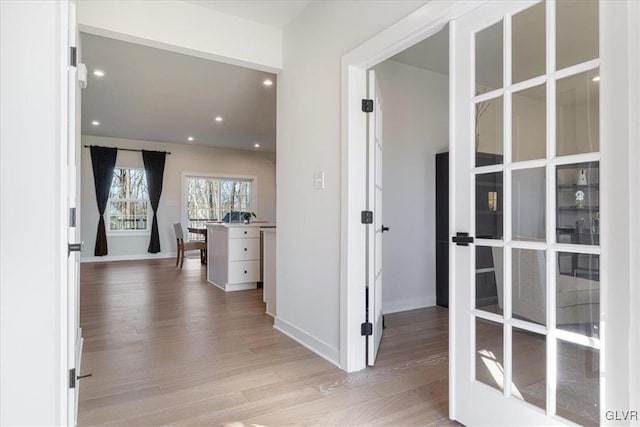 hallway with light hardwood / wood-style floors