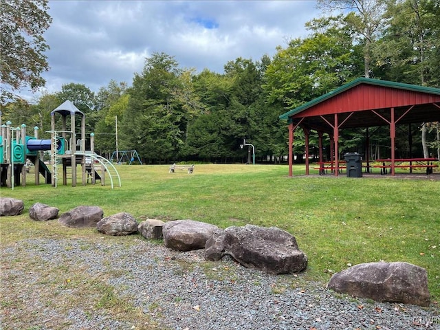 view of property's community featuring a lawn and a playground