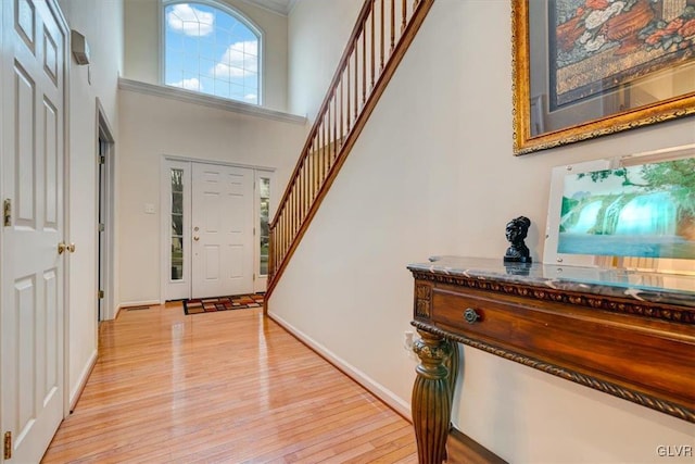 entryway featuring a high ceiling and light hardwood / wood-style floors