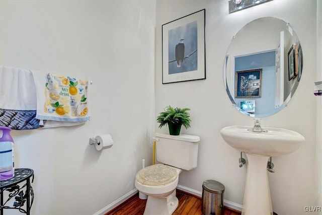 bathroom featuring hardwood / wood-style floors and toilet