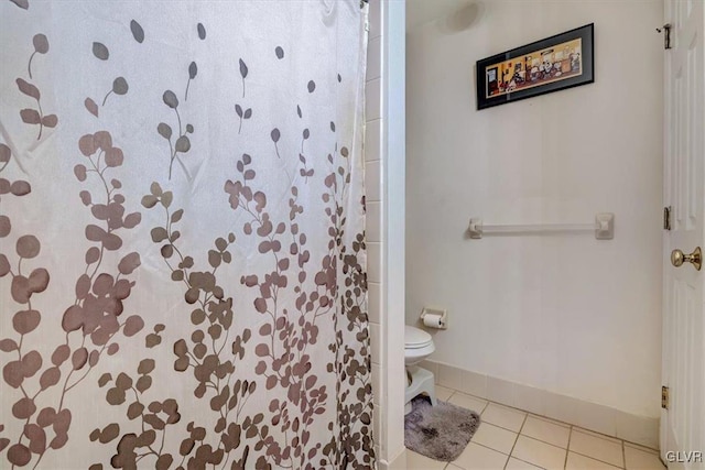 bathroom with toilet and tile patterned floors