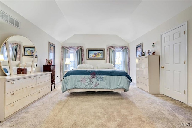 bedroom featuring light carpet and lofted ceiling