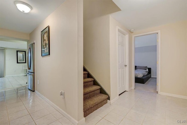 stairway featuring tile patterned flooring