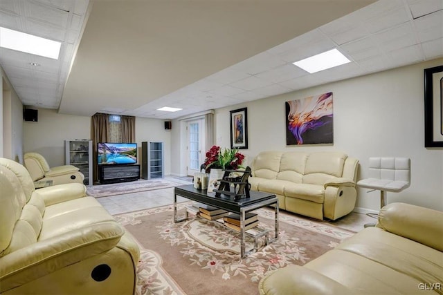 living room featuring a drop ceiling