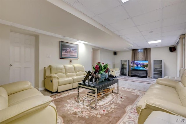 living room with a paneled ceiling