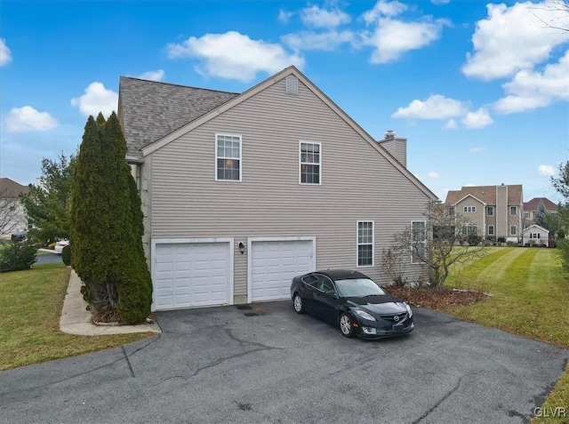 view of property exterior with a lawn and a garage