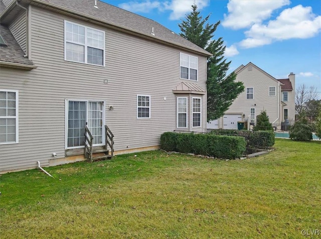 back of house featuring a yard