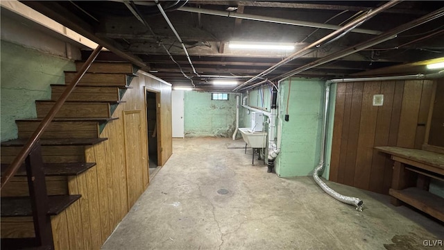 basement featuring wood walls