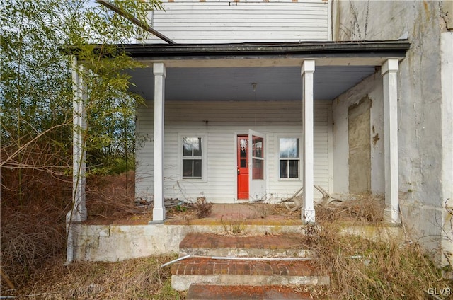 view of exterior entry with a porch