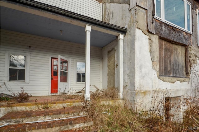 view of exterior entry featuring a porch