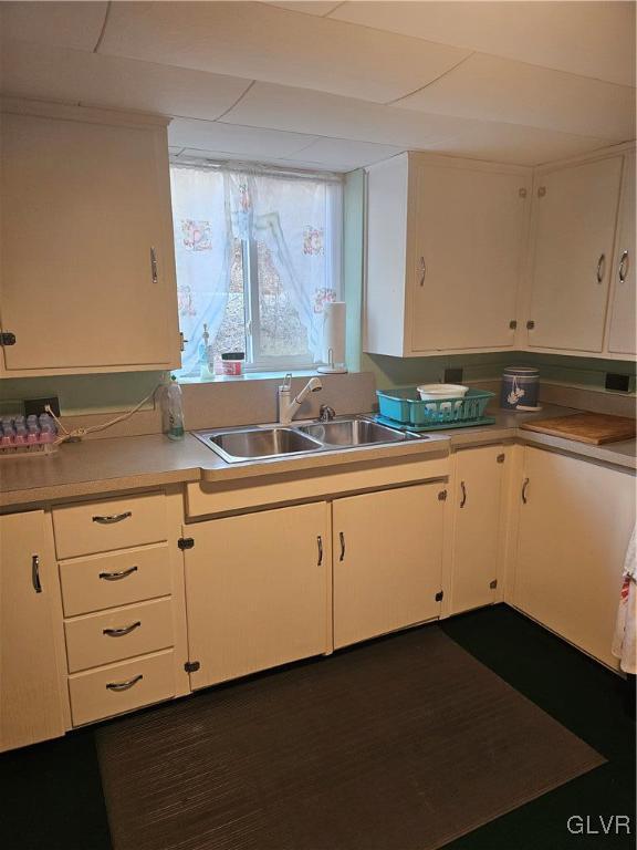 kitchen with white cabinetry and sink