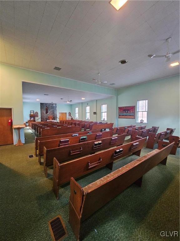 misc room with carpet flooring and ceiling fan