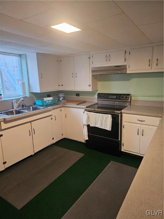 kitchen with white cabinets, sink, and black electric range