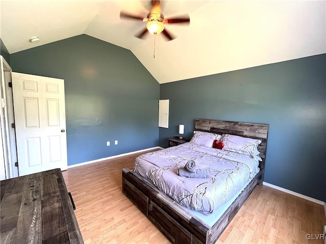 bedroom featuring ceiling fan, light wood-type flooring, and vaulted ceiling