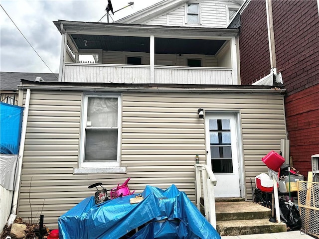 back of property with a balcony