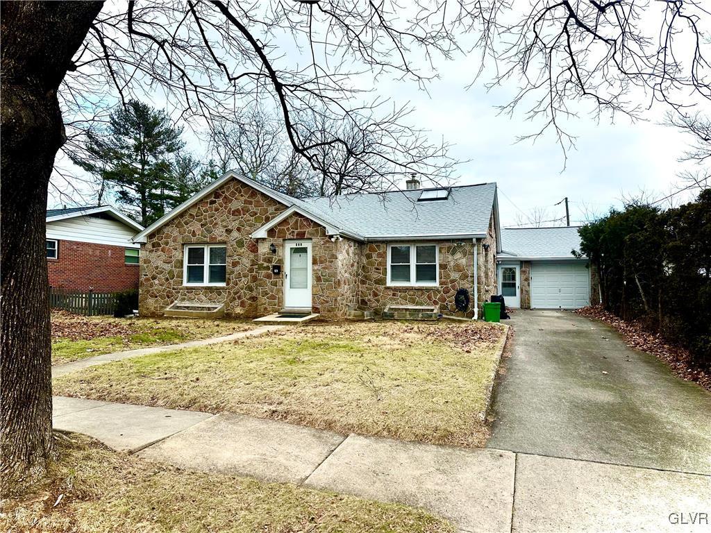 ranch-style home with a front lawn and a garage