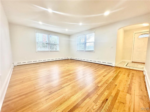 spare room with light hardwood / wood-style flooring and a baseboard heating unit