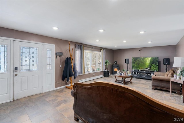 living room with a wood stove and a baseboard heating unit