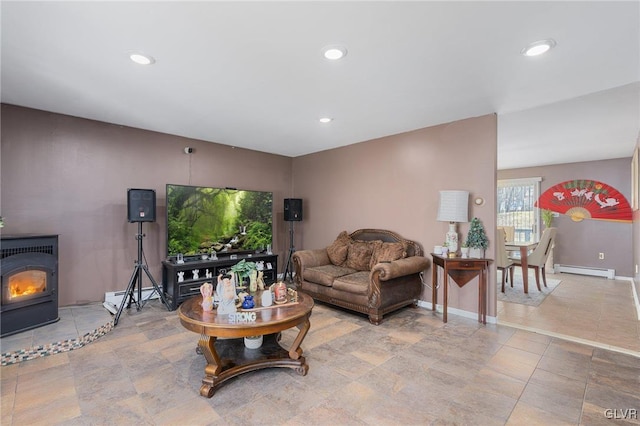 living room with a wood stove and baseboard heating