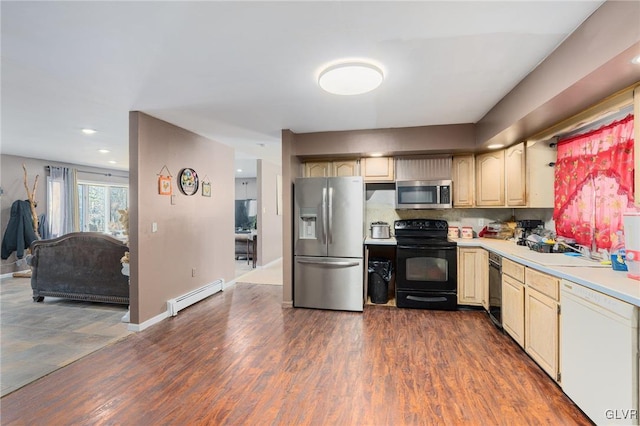 kitchen featuring dark wood-type flooring, stainless steel appliances, tasteful backsplash, and a baseboard heating unit