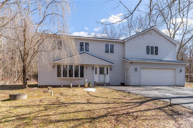 front of property with a garage and a front lawn