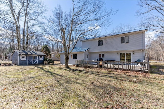 back of house featuring a storage shed, a deck, and a yard