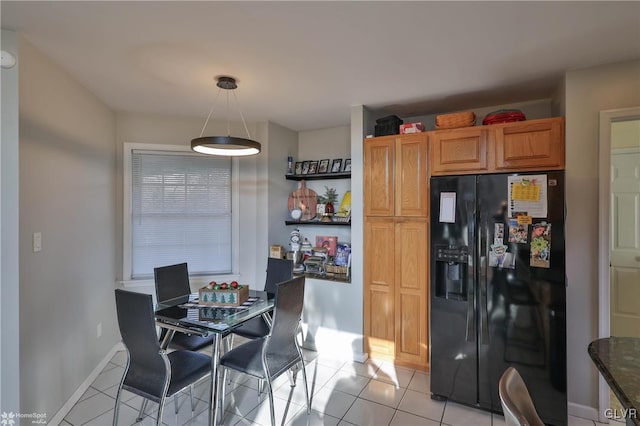 kitchen with decorative light fixtures, light tile patterned flooring, and black refrigerator with ice dispenser