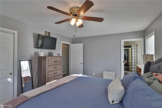 bedroom featuring ceiling fan and connected bathroom