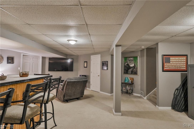 bar featuring light carpet and a drop ceiling