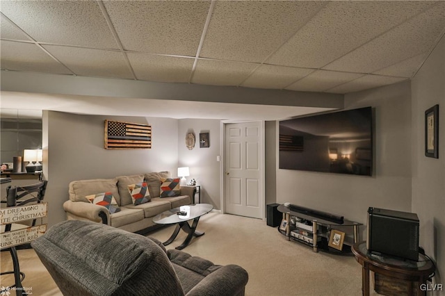 living room featuring carpet flooring and a paneled ceiling