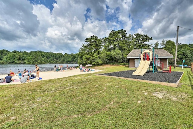 exterior space with a playground and a water view