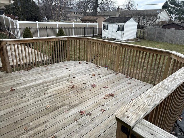 wooden terrace with a storage shed