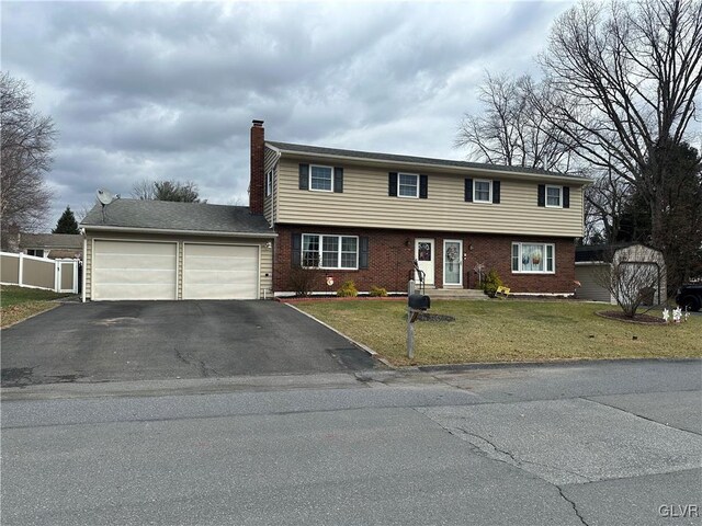 view of front of property with a front yard and a garage