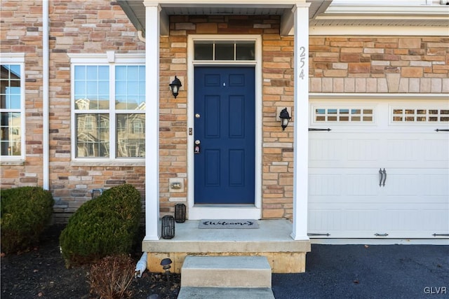 doorway to property featuring a garage