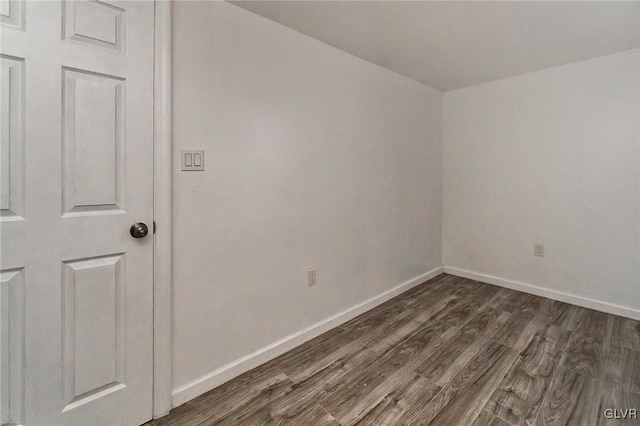 empty room featuring dark wood-type flooring