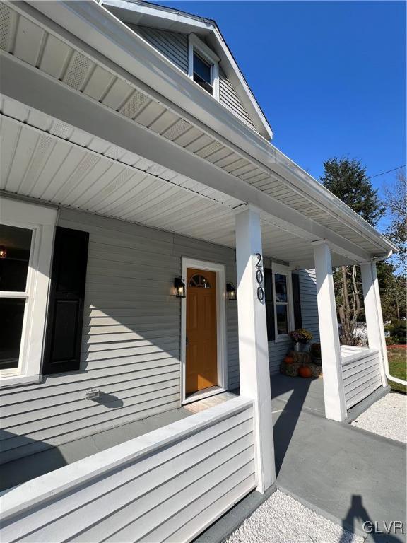 doorway to property featuring a porch