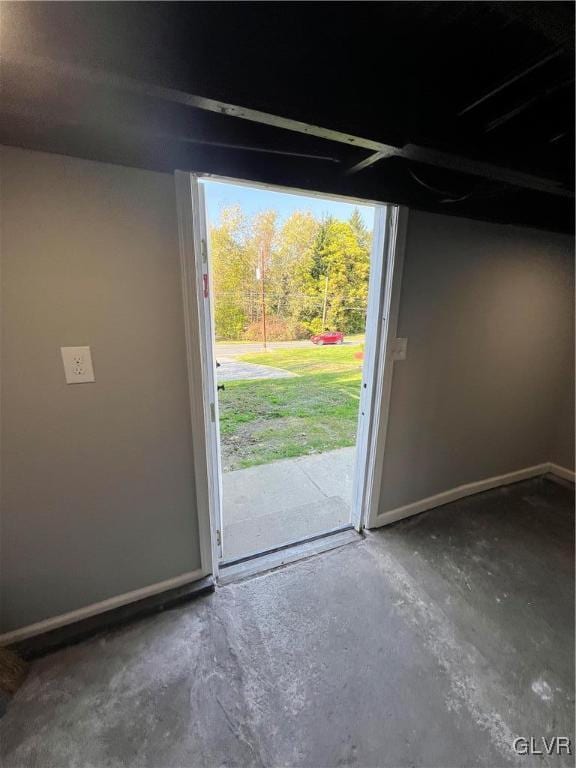 doorway to outside featuring concrete floors