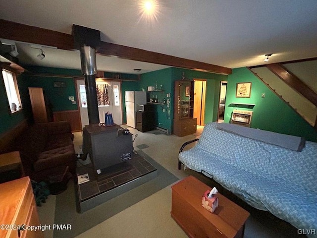 bedroom with beamed ceiling, white refrigerator with ice dispenser, and multiple windows