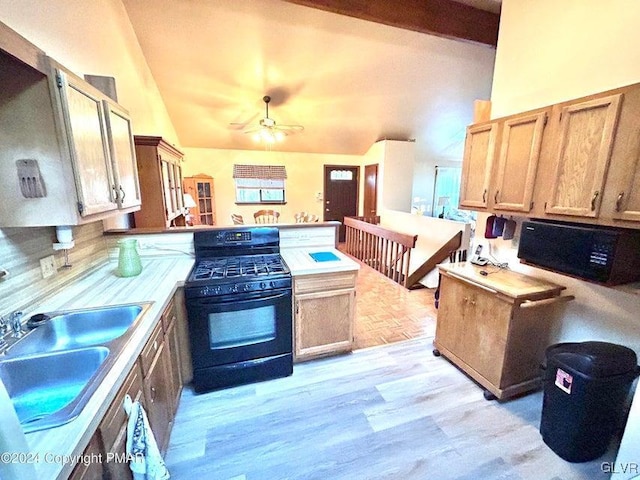 kitchen with black range with gas stovetop, ceiling fan, sink, lofted ceiling with beams, and light hardwood / wood-style flooring