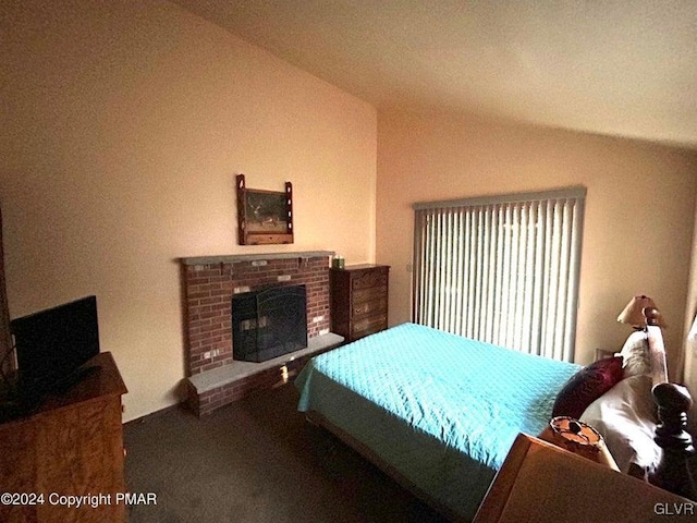 bedroom featuring lofted ceiling and a fireplace