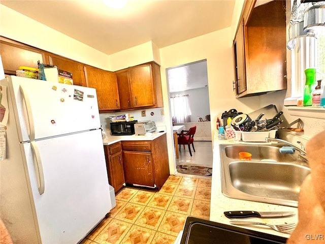 kitchen with white refrigerator and sink