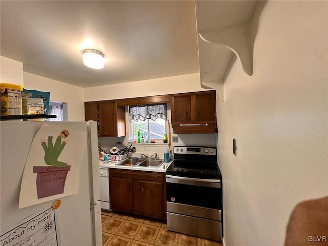 kitchen with dark brown cabinets, sink, and white appliances