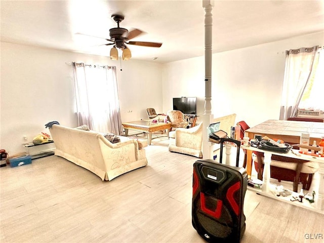 living room featuring ceiling fan and light wood-type flooring