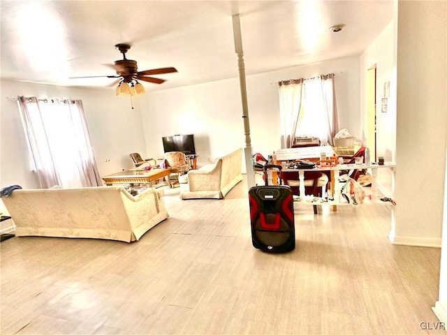 living room featuring light hardwood / wood-style flooring and ceiling fan