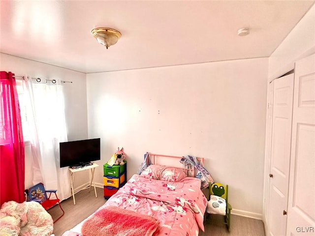 bedroom with dark wood-type flooring