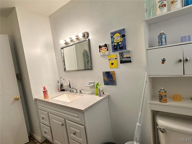 bathroom featuring vanity and toilet