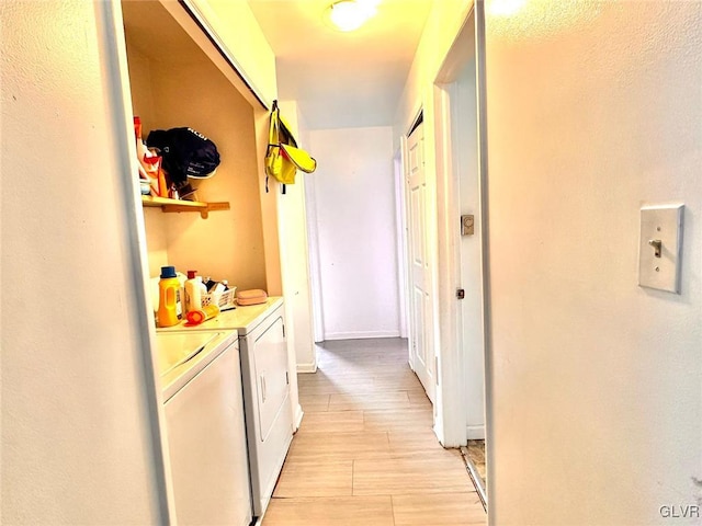 corridor featuring washing machine and dryer and light hardwood / wood-style floors