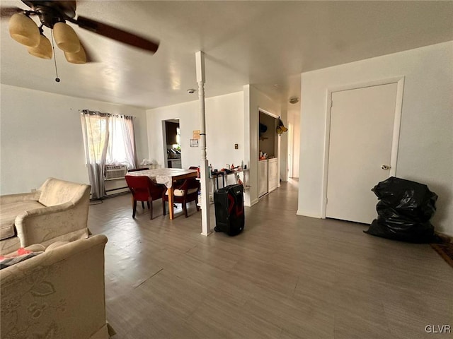 living room featuring ceiling fan and wood-type flooring